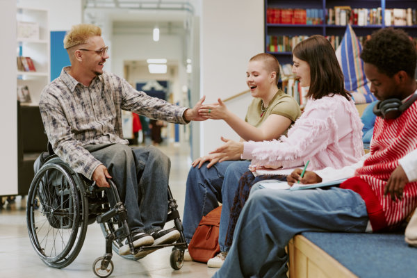 group of friends interacting in modern library