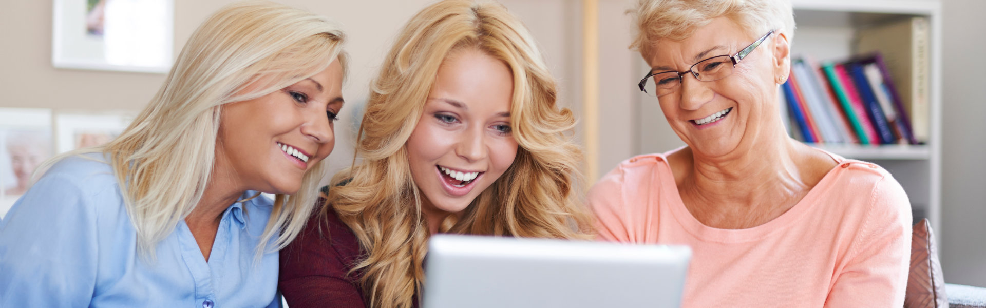 three person looking at a tablet