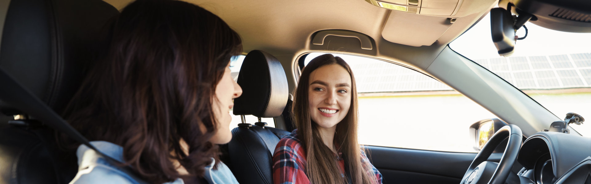 two women smiling in a car